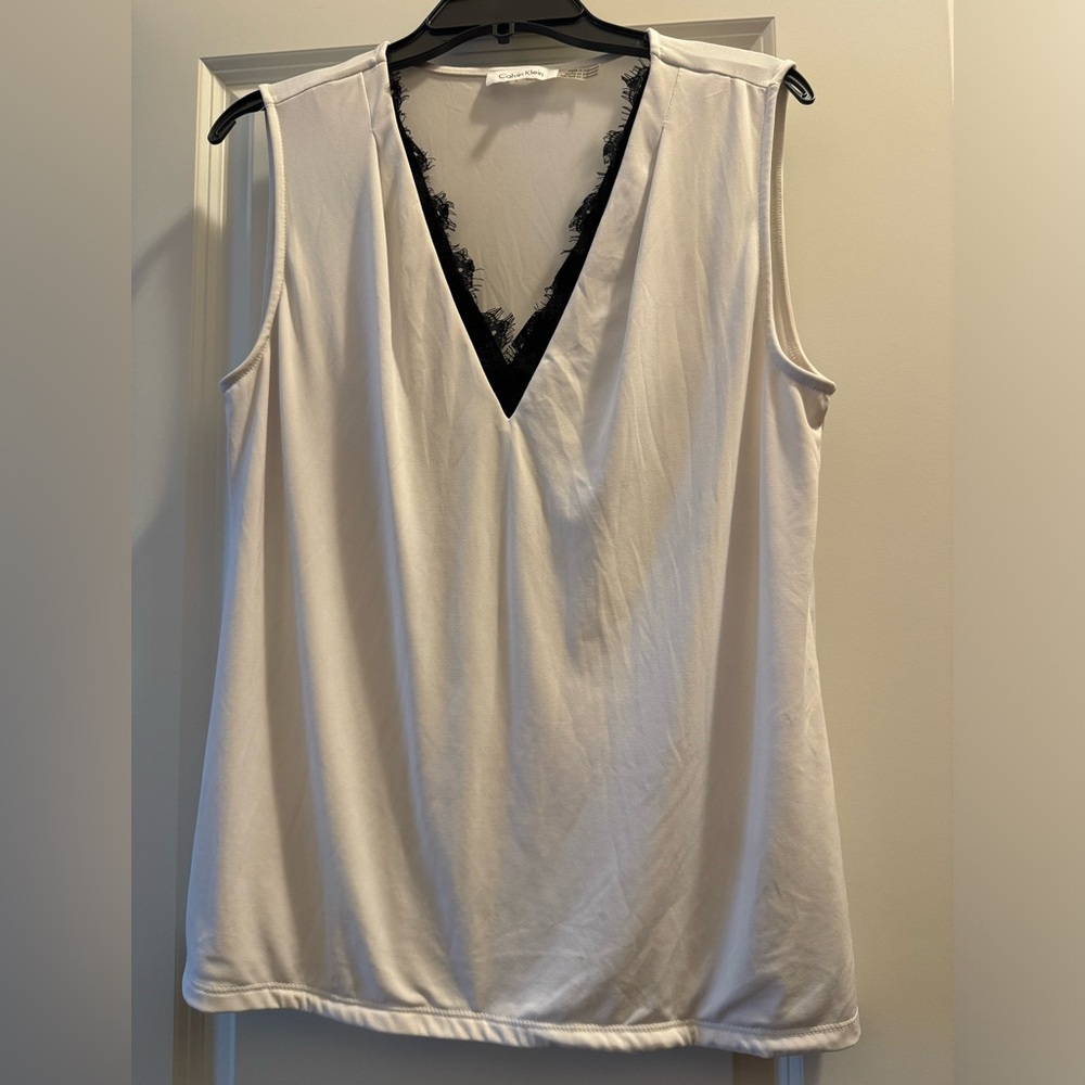 White v-neck dress blouse with black detail along neckline